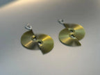 Contemporary gold-tone fan-shaped earrings with geometric cutout design on a neutral background.